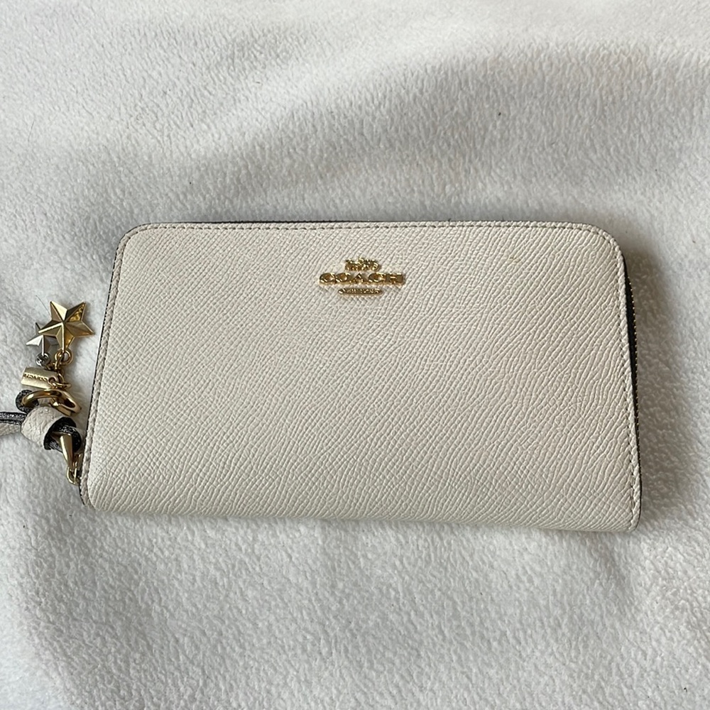 Coach wristlet. Soft white with black interior. Slots for 6 cards. Zipper pocket